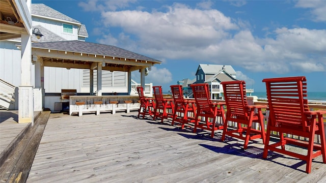 wooden deck featuring a grill