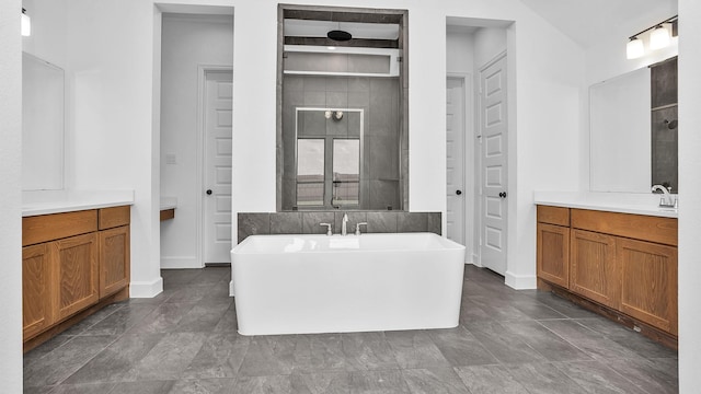 24618 Celestial Lily Dr, Katy, TX 77493 - bathroom featuring a freestanding tub, baseboards, vanity, and tiled shower