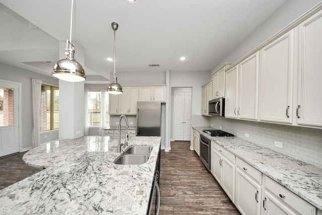 kitchen with recessed lighting, a sink, visible vents, appliances with stainless steel finishes, and tasteful backsplash