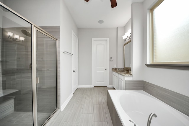 full bath with a garden tub, a shower stall, vanity, and baseboards