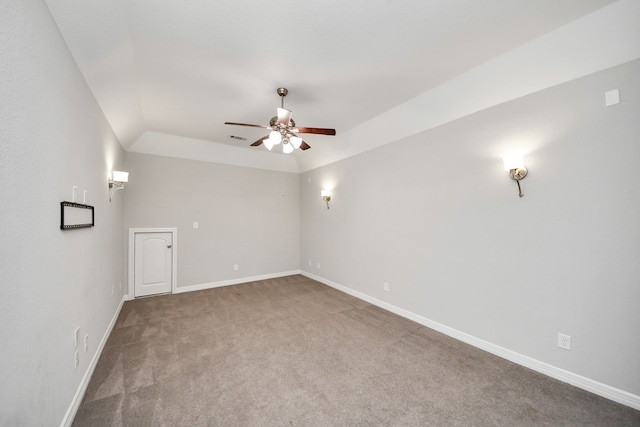 unfurnished room featuring carpet floors, visible vents, baseboards, and a ceiling fan