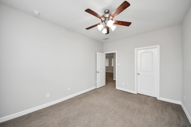 unfurnished bedroom with ceiling fan, carpet flooring, and baseboards