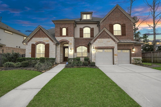 view of front of house with driveway, stone siding, fence, a front lawn, and brick siding