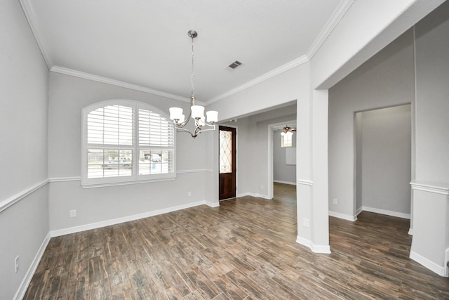 unfurnished dining area featuring baseboards, wood finished floors, visible vents, and crown molding