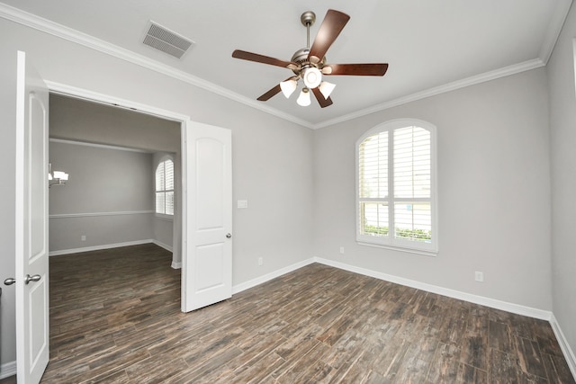 empty room with baseboards, visible vents, and wood finished floors