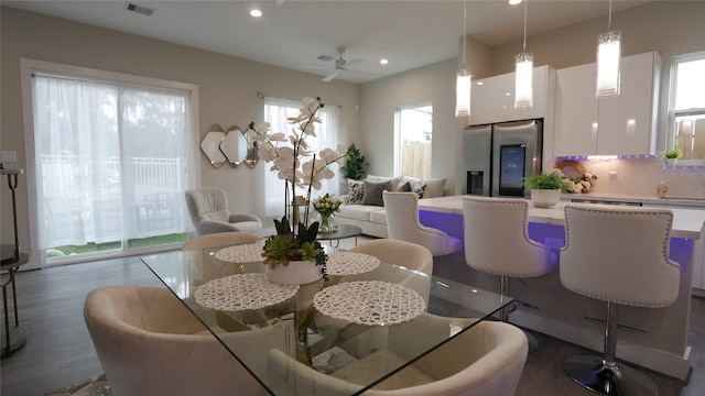 dining space featuring wood finished floors, visible vents, and recessed lighting