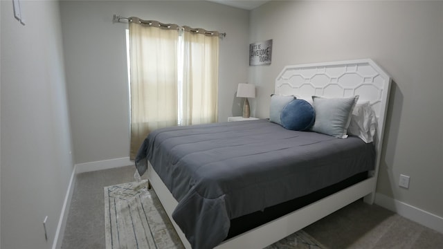 bedroom featuring carpet and baseboards