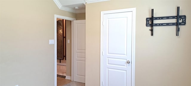 hallway featuring crown molding and light wood-style flooring