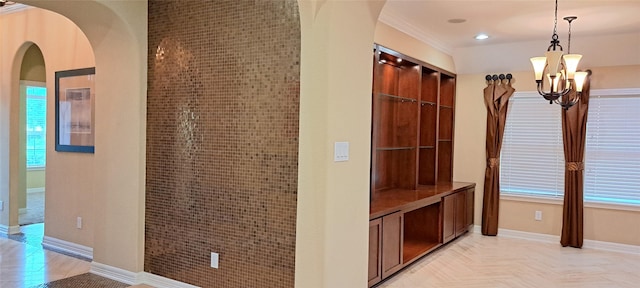 interior space with an inviting chandelier, baseboards, arched walkways, and recessed lighting