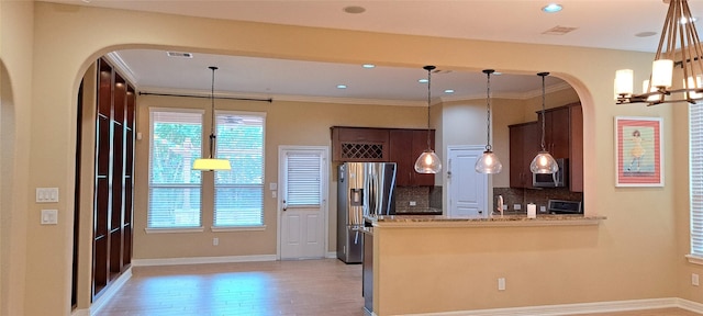 kitchen featuring visible vents, appliances with stainless steel finishes, backsplash, and ornamental molding