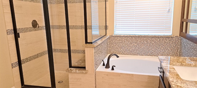 full bath featuring a garden tub and a shower stall