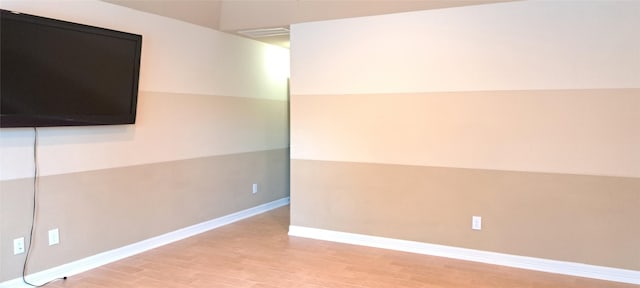 spare room with light wood-style flooring and baseboards