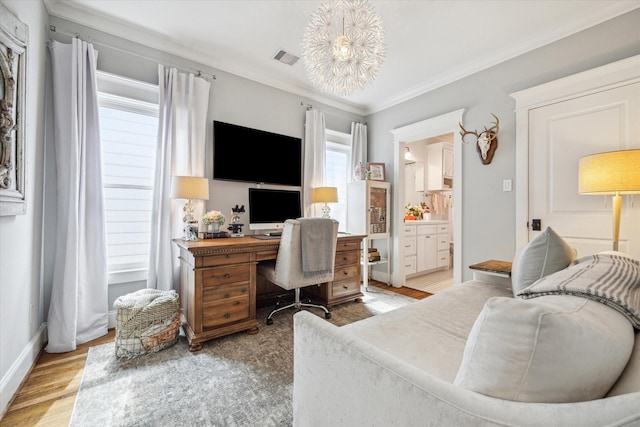 office space featuring ornamental molding, baseboards, visible vents, and light wood finished floors