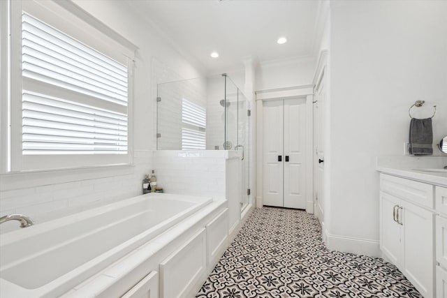 bathroom featuring a garden tub, recessed lighting, a shower stall, vanity, and baseboards