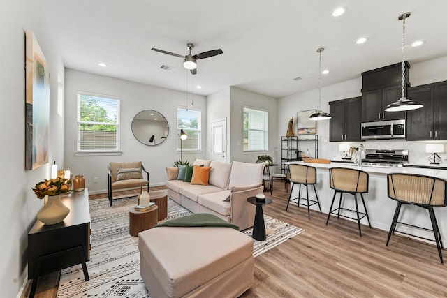 2110 Dewalt St Unit H, Houston, TX 77088 - living area with light wood-type flooring, healthy amount of natural light, recessed lighting, a ceiling fan, and baseboards