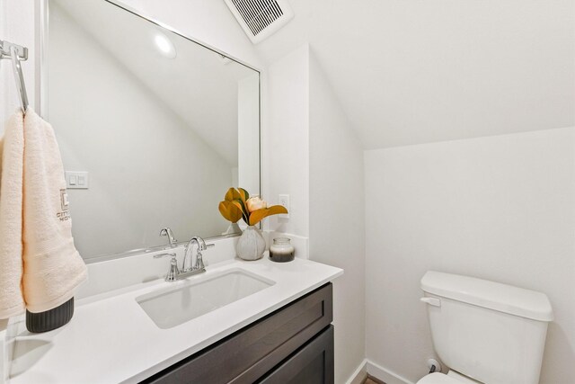2110 Dewalt St Unit H, Houston, TX 77088 - half bathroom with lofted ceiling, vanity, and toilet