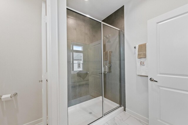 2110 Dewalt St Unit H, Houston, TX 77088 - full bath with baseboards, marble look tiles, and a shower stall