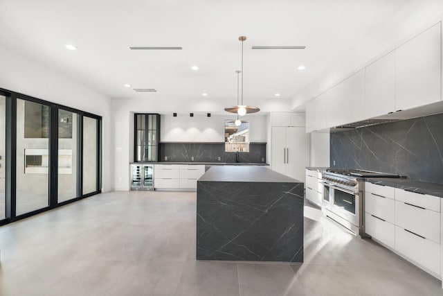 kitchen featuring dark countertops, double oven range, and modern cabinets