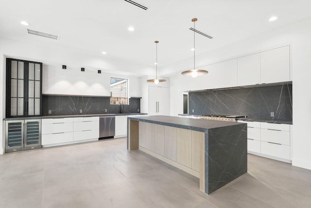 kitchen with visible vents, dark countertops, modern cabinets, white cabinetry, and open shelves