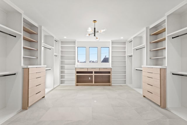 walk in closet featuring an inviting chandelier