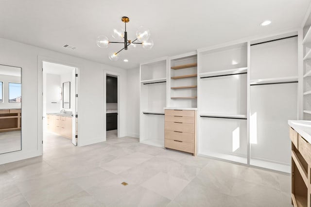 unfurnished bedroom featuring recessed lighting, visible vents, connected bathroom, a sink, and a chandelier