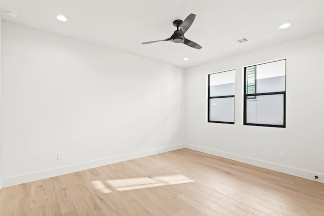 empty room featuring recessed lighting, visible vents, baseboards, and wood finished floors