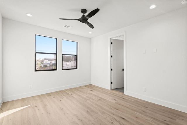 empty room featuring visible vents, recessed lighting, light wood-style flooring, and baseboards