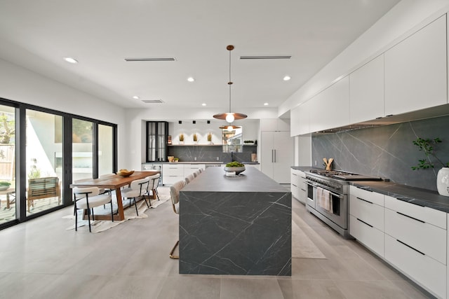 1225 Althea Dr, Houston, TX 77018 - kitchen featuring double oven range, modern cabinets, white cabinetry, dark countertops, and decorative backsplash