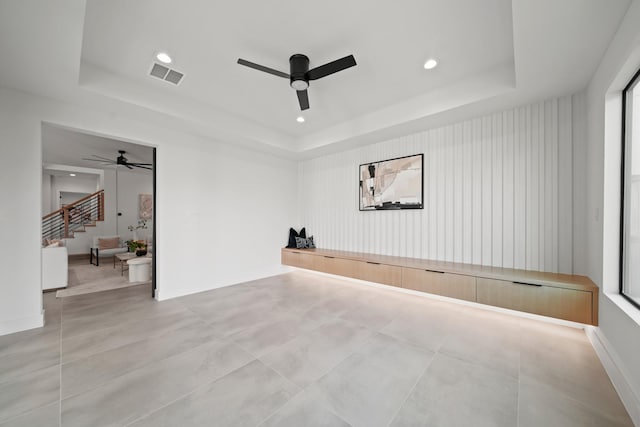 1225 Althea Dr, Houston, TX 77018 - spare room with a ceiling fan, a tray ceiling, recessed lighting, and stairway