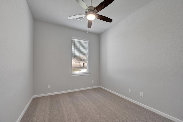 unfurnished room featuring light colored carpet, ceiling fan, and baseboards