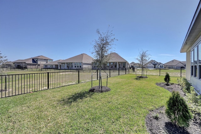 view of yard featuring a fenced backyard and a residential view