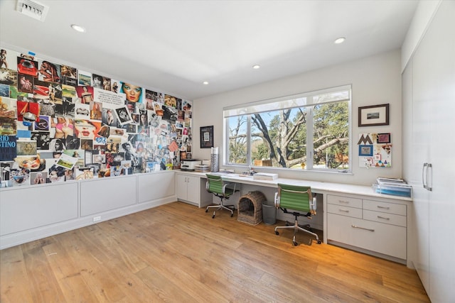 unfurnished office with light wood-style floors, recessed lighting, visible vents, and built in study area