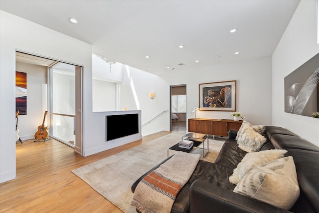 living area featuring light wood-style flooring, visible vents, and recessed lighting