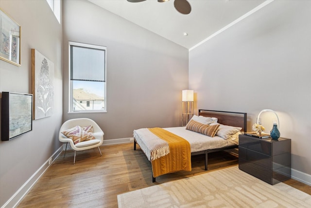 bedroom with high vaulted ceiling, baseboards, hardwood / wood-style floors, and recessed lighting