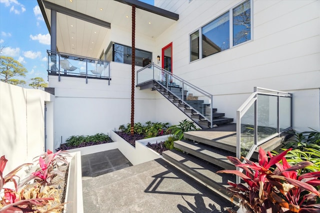 view of patio / terrace with fence and stairway