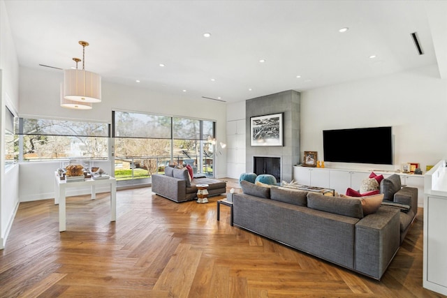 living room with recessed lighting and a fireplace