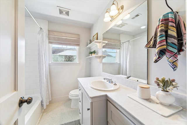 bathroom featuring toilet, vanity, visible vents, and shower / bathtub combination with curtain