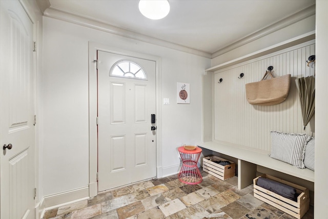 mudroom featuring stone tile floors and baseboards