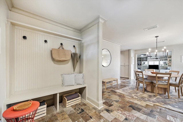 mudroom featuring ornamental molding, stone tile flooring, and visible vents