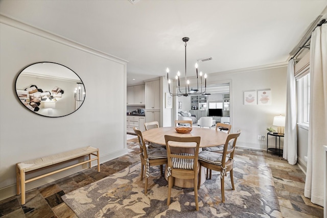 dining area with baseboards, visible vents, crown molding, stone tile flooring, and a chandelier