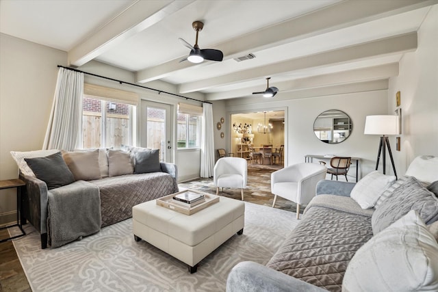 living room with visible vents, ceiling fan, and beamed ceiling