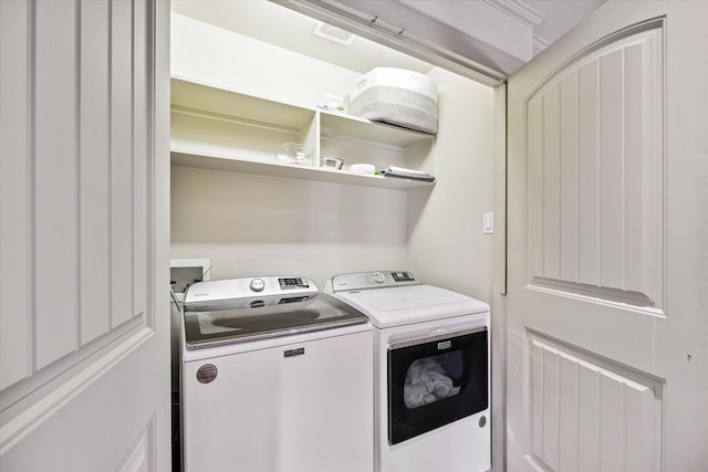 laundry area with washer and dryer, laundry area, and visible vents