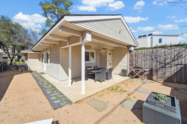 exterior space with fence and a ceiling fan