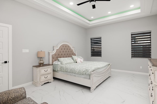 bedroom featuring a tray ceiling, recessed lighting, and baseboards