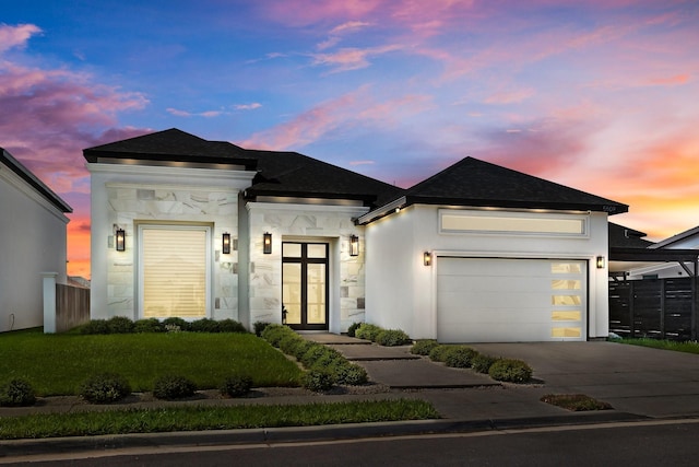 view of front of property with a shingled roof, driveway, an attached garage, and fence