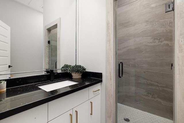 bathroom featuring a shower stall and vanity