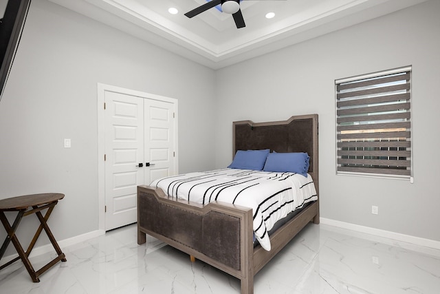 bedroom featuring recessed lighting, marble finish floor, and baseboards