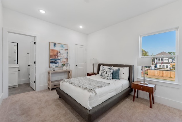 bedroom featuring carpet floors, recessed lighting, ensuite bath, and baseboards