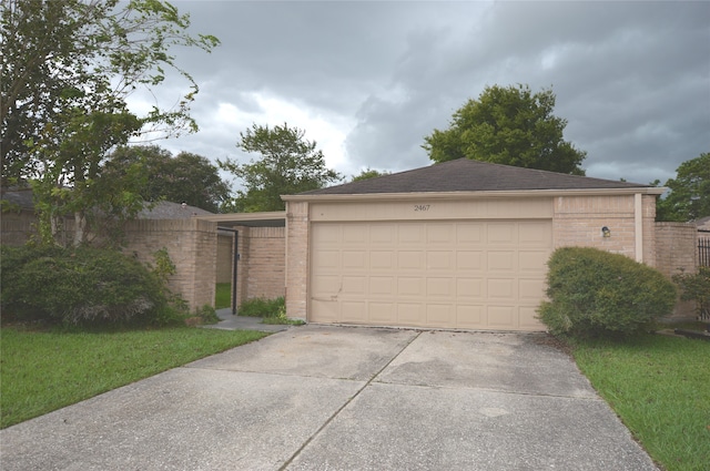 garage featuring concrete driveway