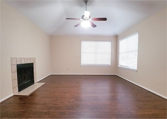 unfurnished living room featuring ceiling fan, a fireplace, wood finished floors, and baseboards